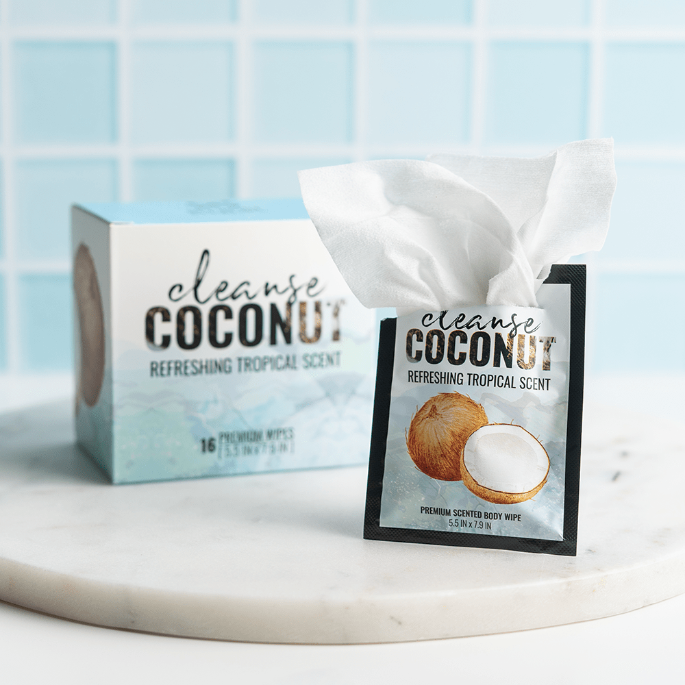 Alchemy Cleanse Coconut Scented Wipes on marble surface with light blue tile background