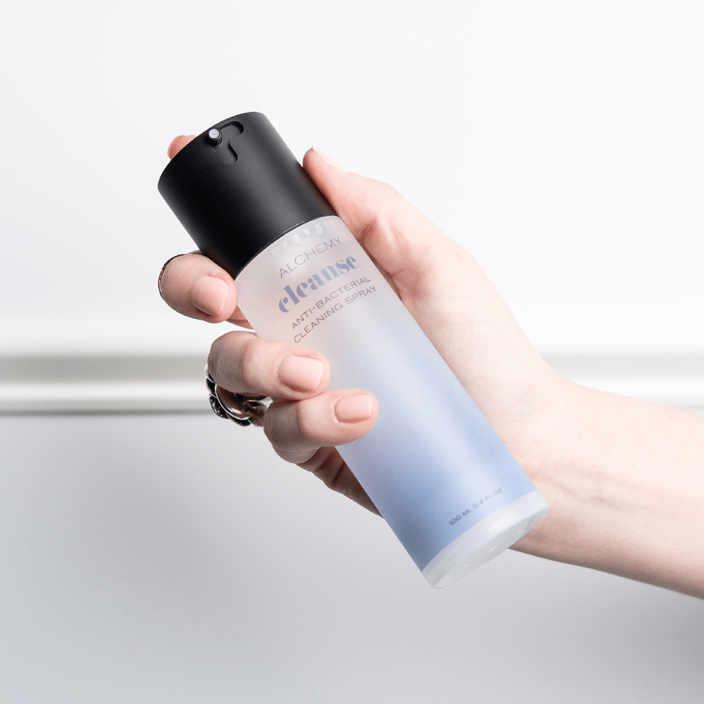Alchemy Cleanse Antibacterial Toy Cleaner bottle in woman's hand