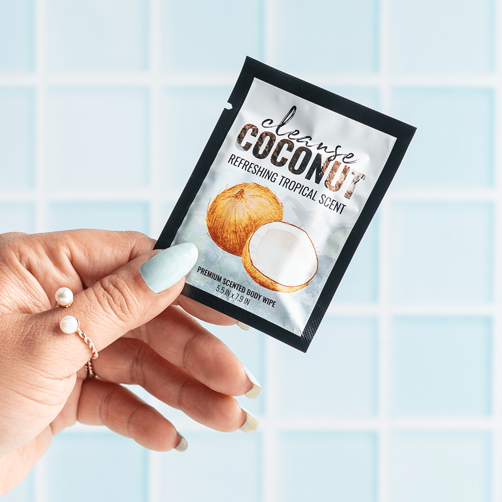 Alchemy Cleanse Coconut Scented Wipes in woman's hand