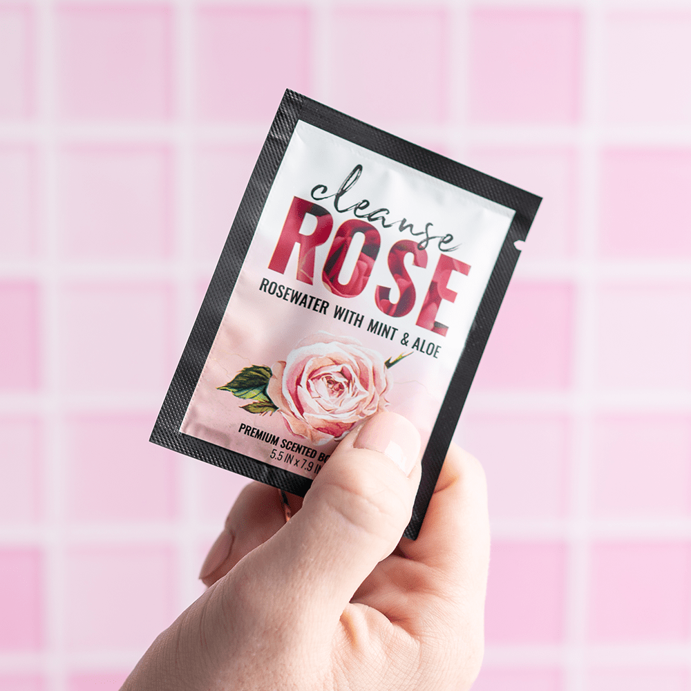 Alchemy Cleanse Rosewater Scented Wipes in woman's hand
