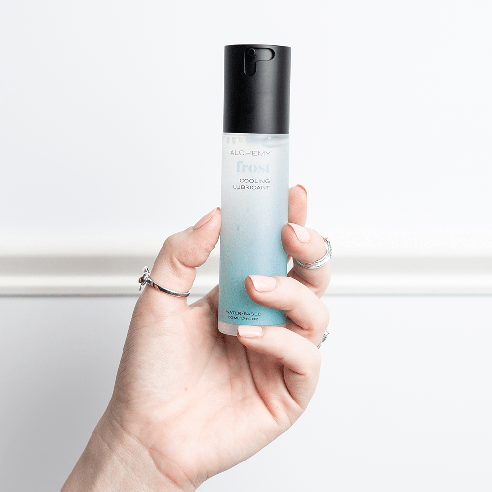 Alchemy Frost: Water-Based Cooling Personal Lubricant bottle in woman's hand