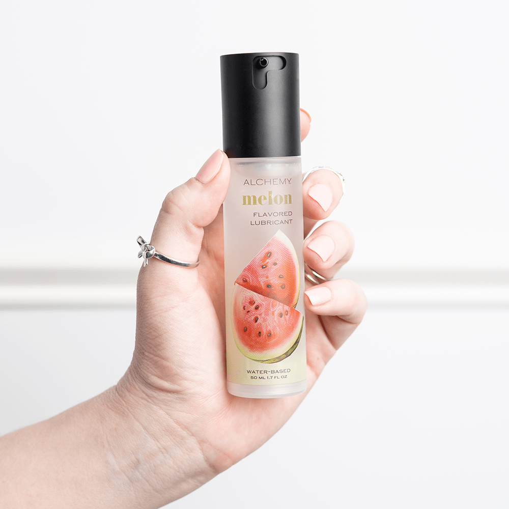 Alchemy Indulge: Watermelon Flavored Personal Lubricant bottle in woman's hand