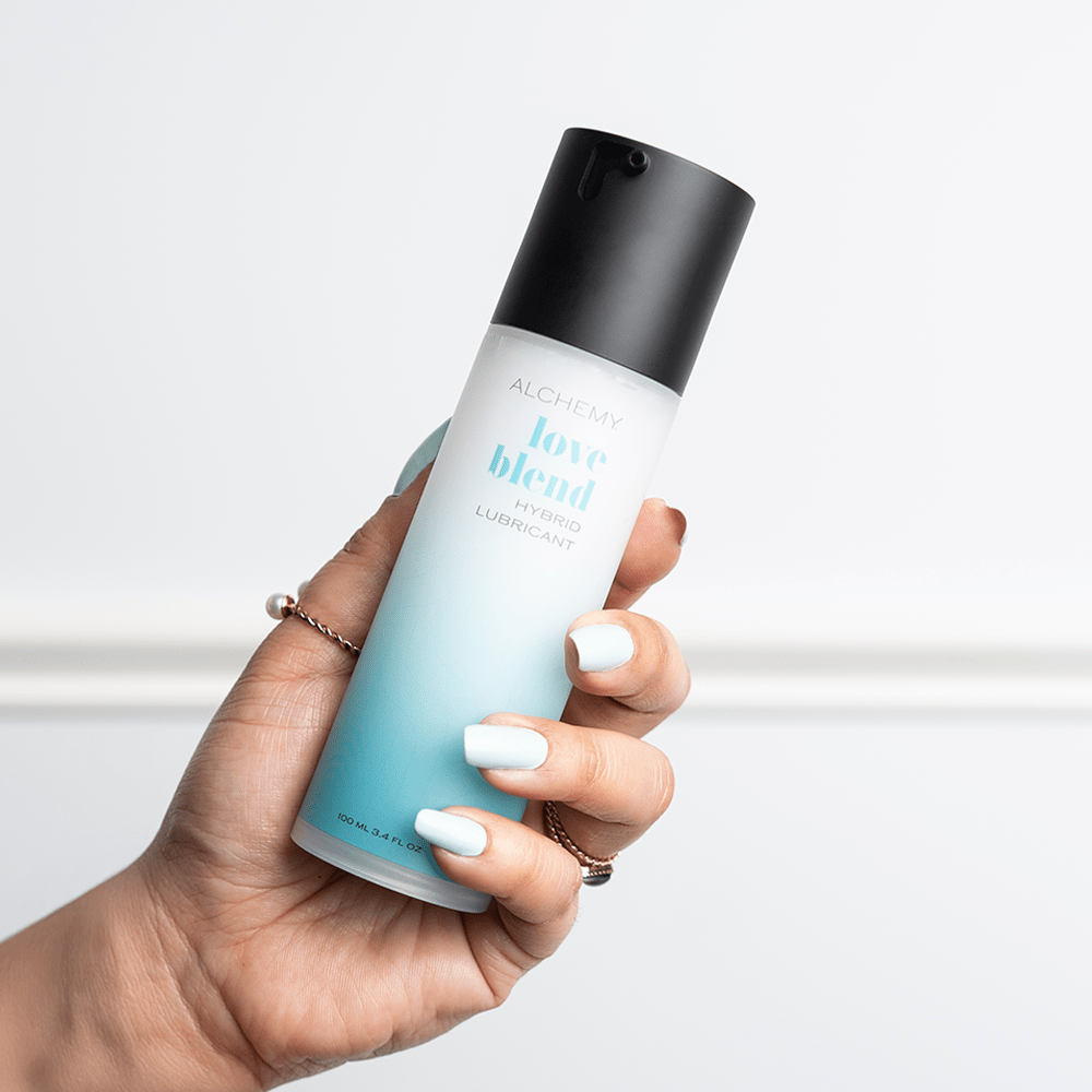 Alchemy Love Blend: Hybrid Personal Lubricant bottle in woman's hand
