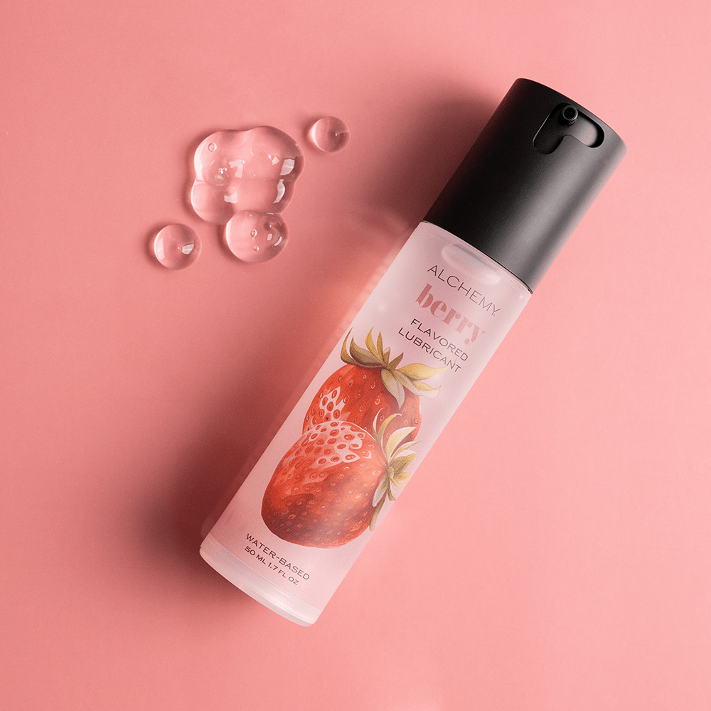Alchemy Indulge: Strawberry Flavored Personal Lubricant bottle with liquid droplets