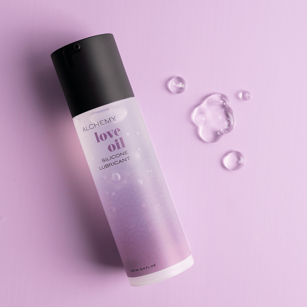 Alchemy Love Oil: Silicone-Based Personal Lubricant bottle with liquid droplets