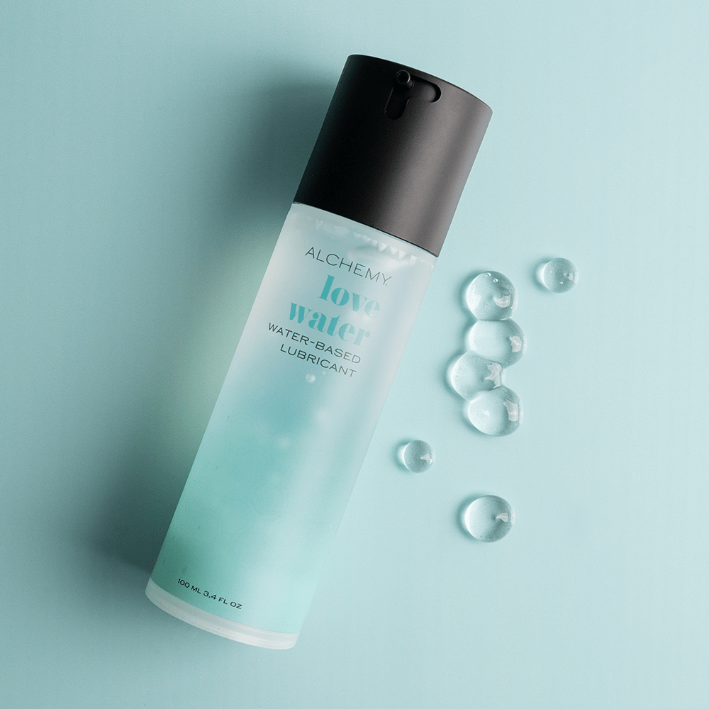 Alchemy Love Water: Water-Based Personal Lubricant bottle with liquid droplets