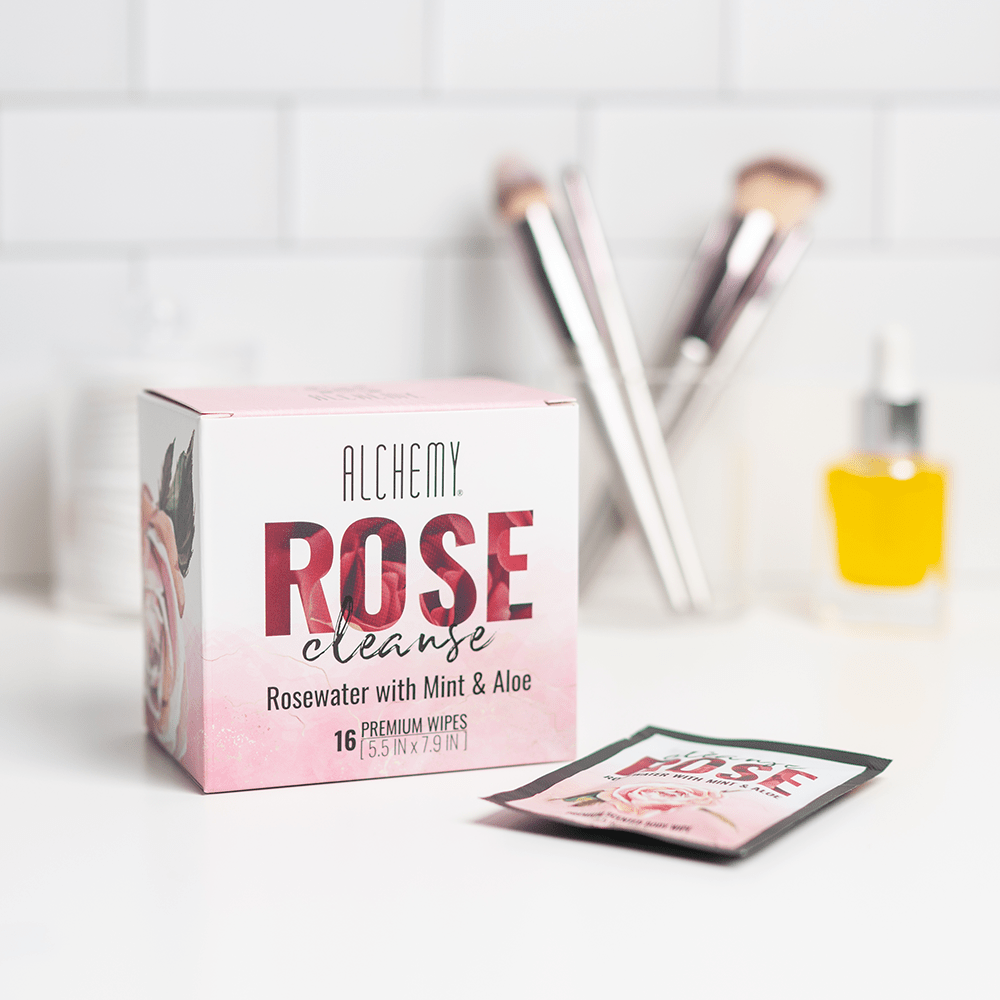 Alchemy Cleanse Rosewater Scented Wipes box on white bathroom counter with makeup applicators in the background