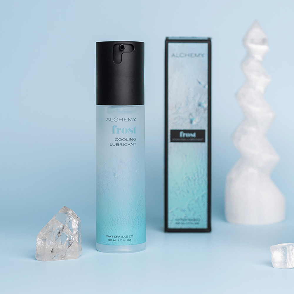 Alchemy Frost: Water-Based Cooling Personal Lubricant with box on blue background with crystals