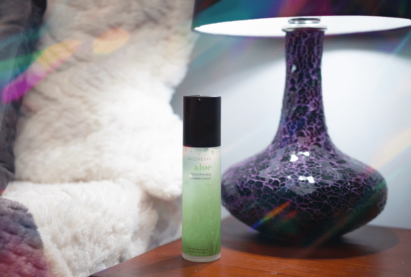 Alchemy Aloe: Hydrating Water-Based Personal Lubricant bottle on nightstand