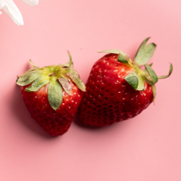 Top view of strawberries on a pink background