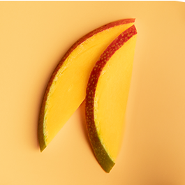 Top view of mango slices on a yellow background