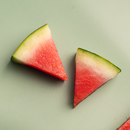 Top view of watermelon slices on a green background