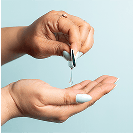 Alchemy Love Water Water-Based Snap + Slide Single-Use Personal Lubricant Packets – woman's hands holding folded packet with lube drop